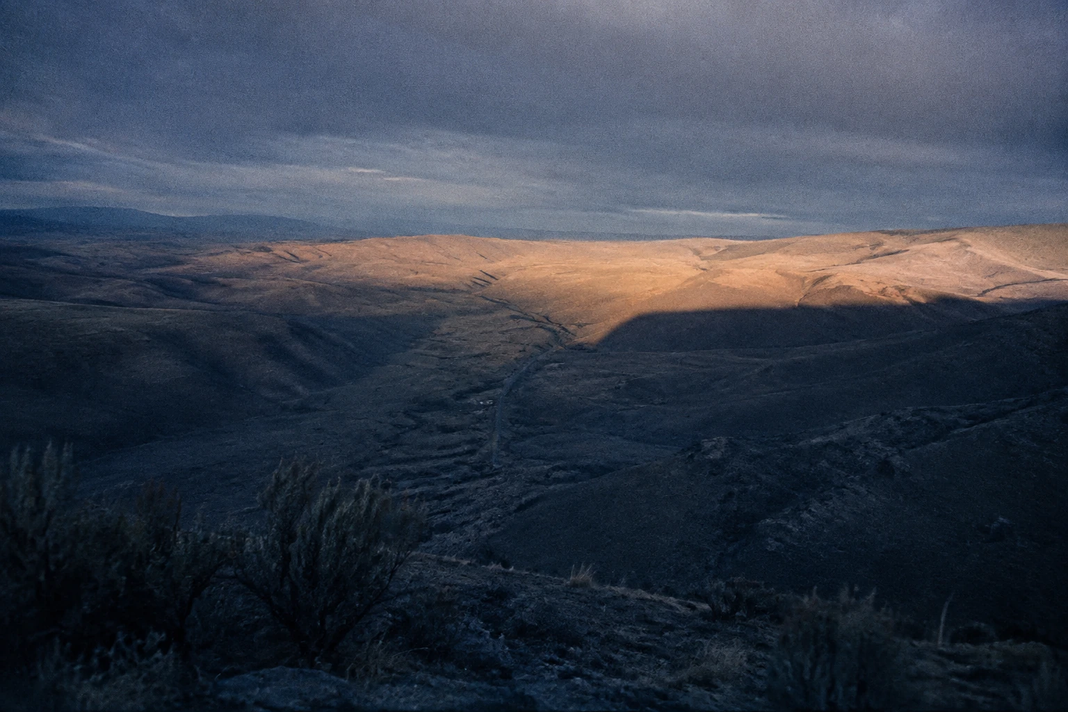 A broad dark band crossing the dry hills of central Washington.